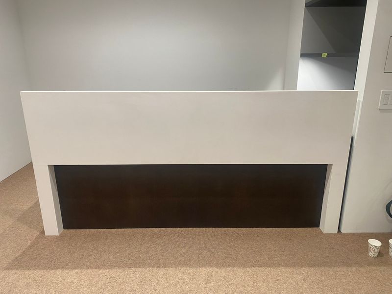 Dark brown wood reception desk with drawers